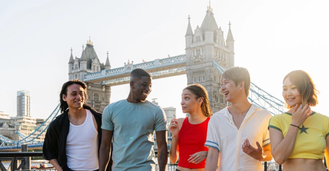 Multiracial group of happy young friends bonding in London